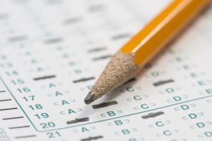 Standardized test form with answers bubbled in and a pencil resting on the paper with a shallow depth of field