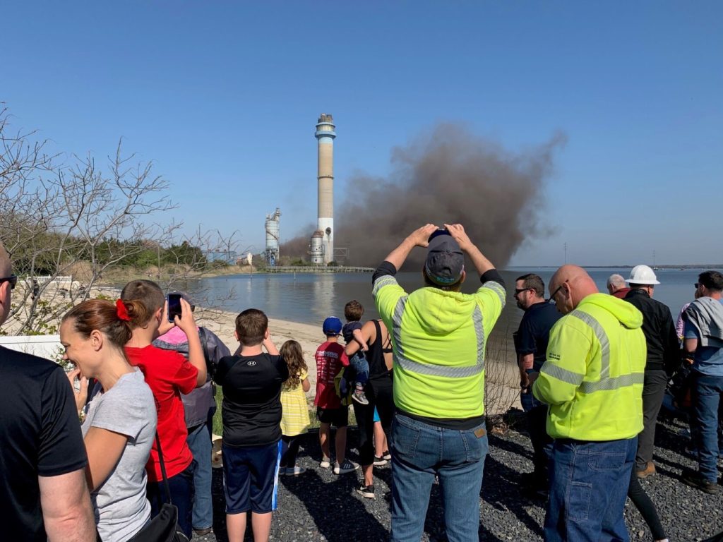 <p>People record the demolition of the boilers at the former B.L. England Generating Station