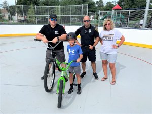 The Rotary Club of Lower Township and the Lower Township Police Department cooperated on the first Rotary Junior Bike Rodeo, July 22, at the Clem Mulligan Sports Complex in Villas. The joint effort was intended to promote bike safety among area youth. Shown are Patrolman Lou Bartleson, Barrett Bartleson, Patrolman Michael Nuscis, and Laurie Wooster from the Rotary Club.