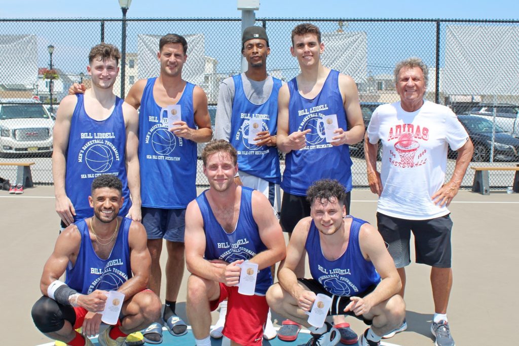 The winners of the 2023 Bill Liddell Men’s Basketball Tournament are shown following the championship game on July 8: (kneeling