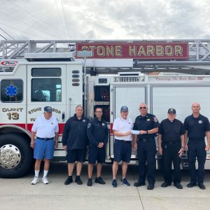 Post 331 Trustee Jon Ready Presents Donation to Fire Chief Roger Stanford as Members of the Stone Harbor Volunteer Fire Company and Post 331 Look On