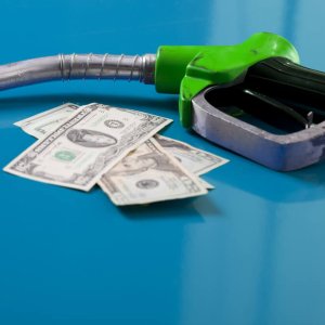 Gas,Price,Concept.,American,Dollars,And,Fuel,Nozzle